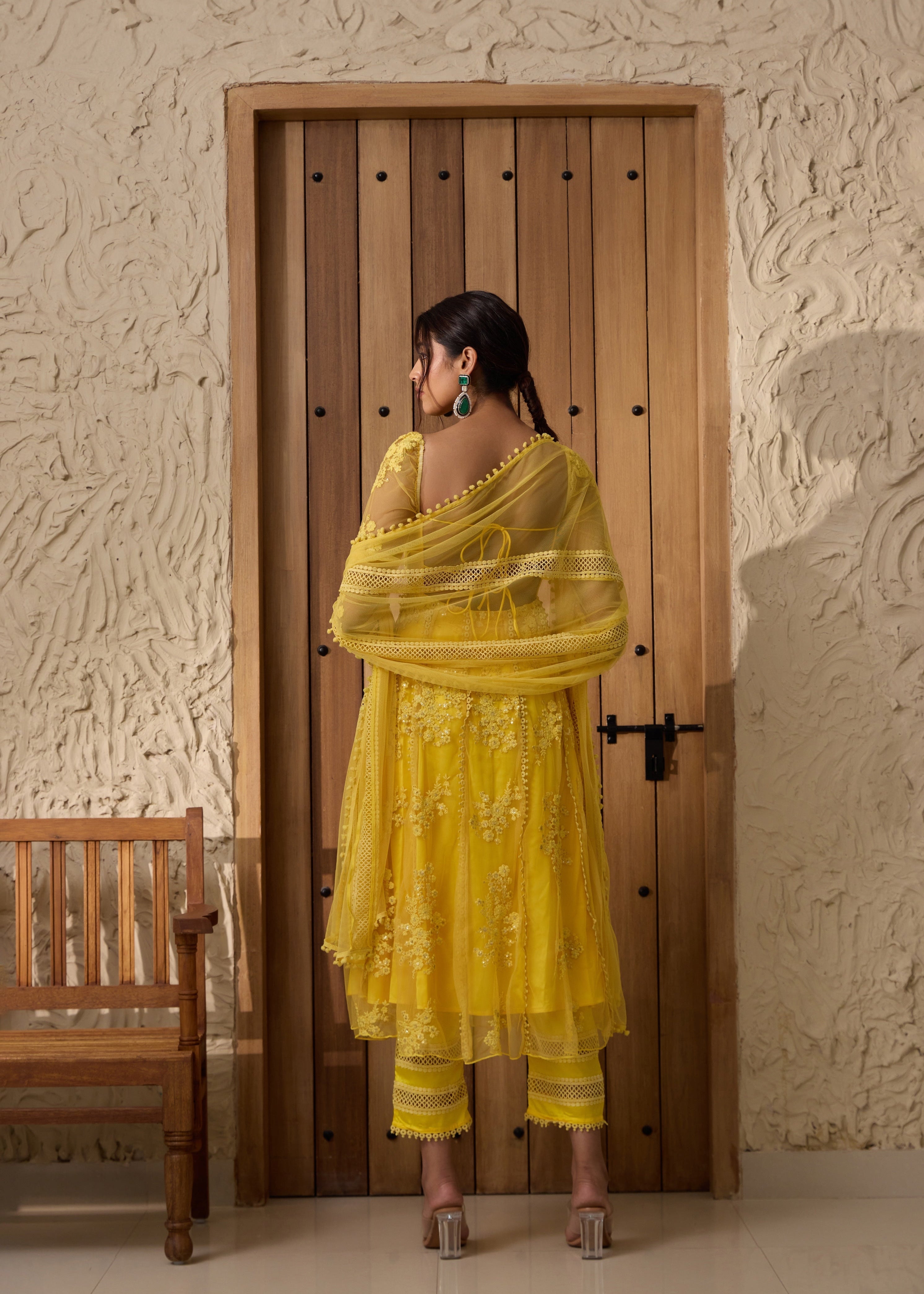 A yellow Anarkali suit set with an embroidered corset top.