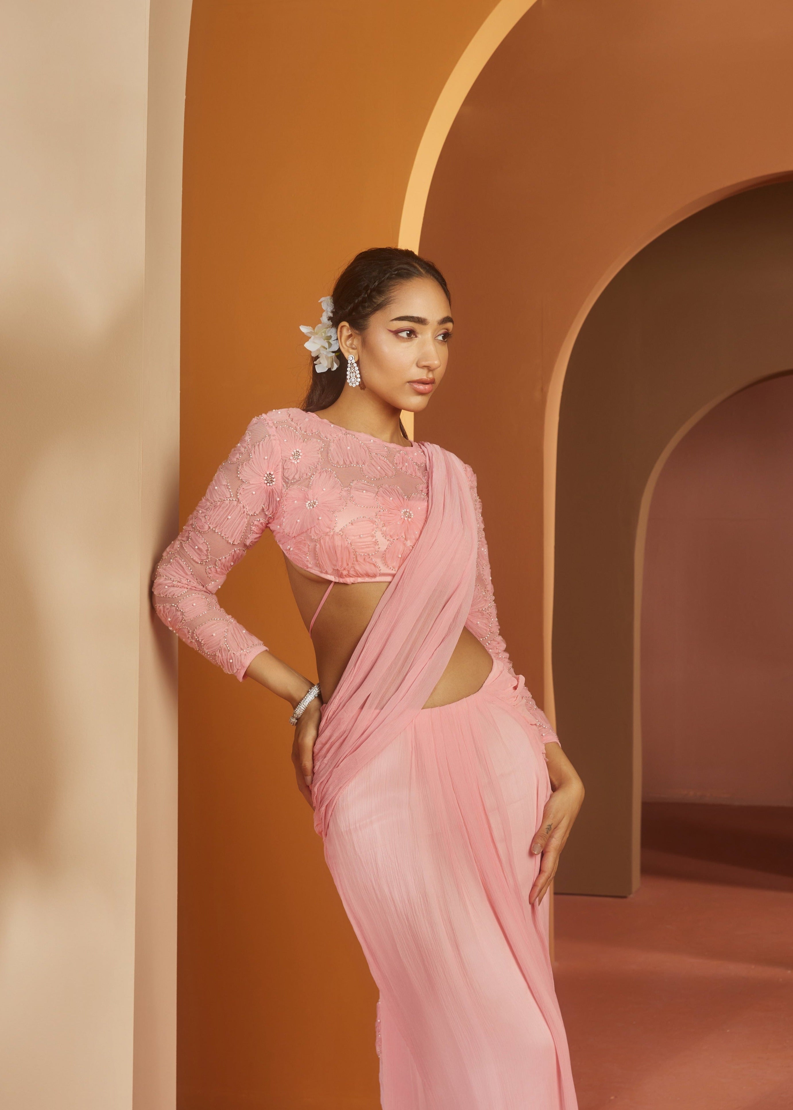 Graceful woman in a Sarika Pink Flower Embroidery Pre-Draped Saree Set, radiating floral elegance and charm
