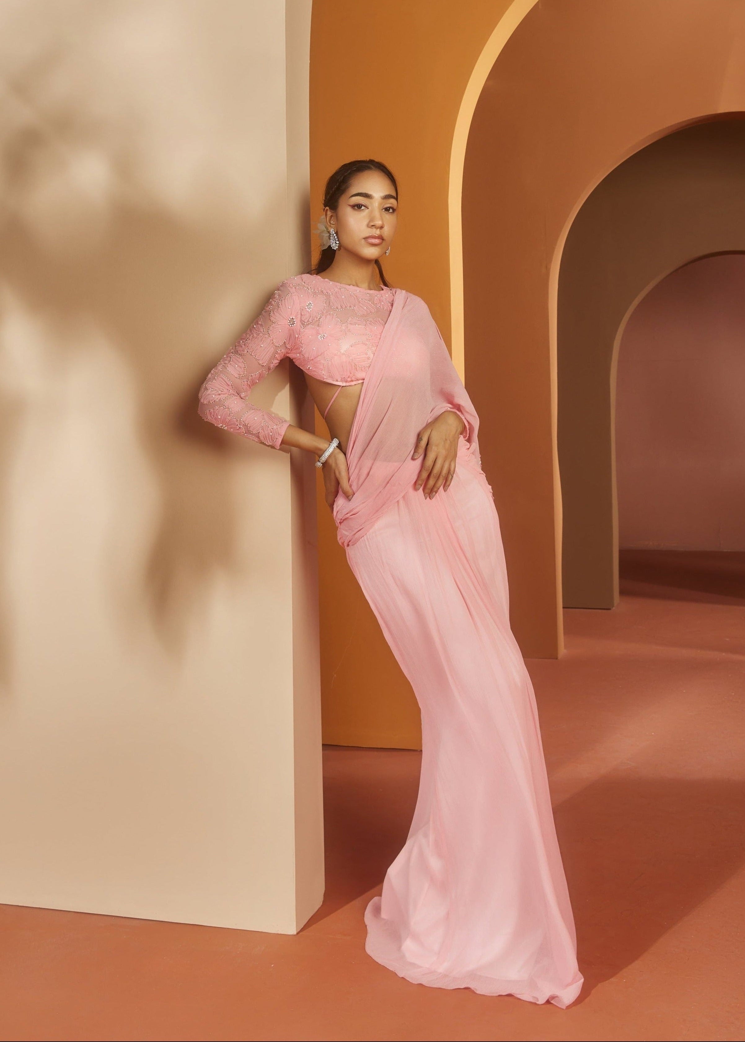Graceful woman in a Sarika Pink Flower Embroidery Pre-Draped Saree Set, radiating floral elegance and charm