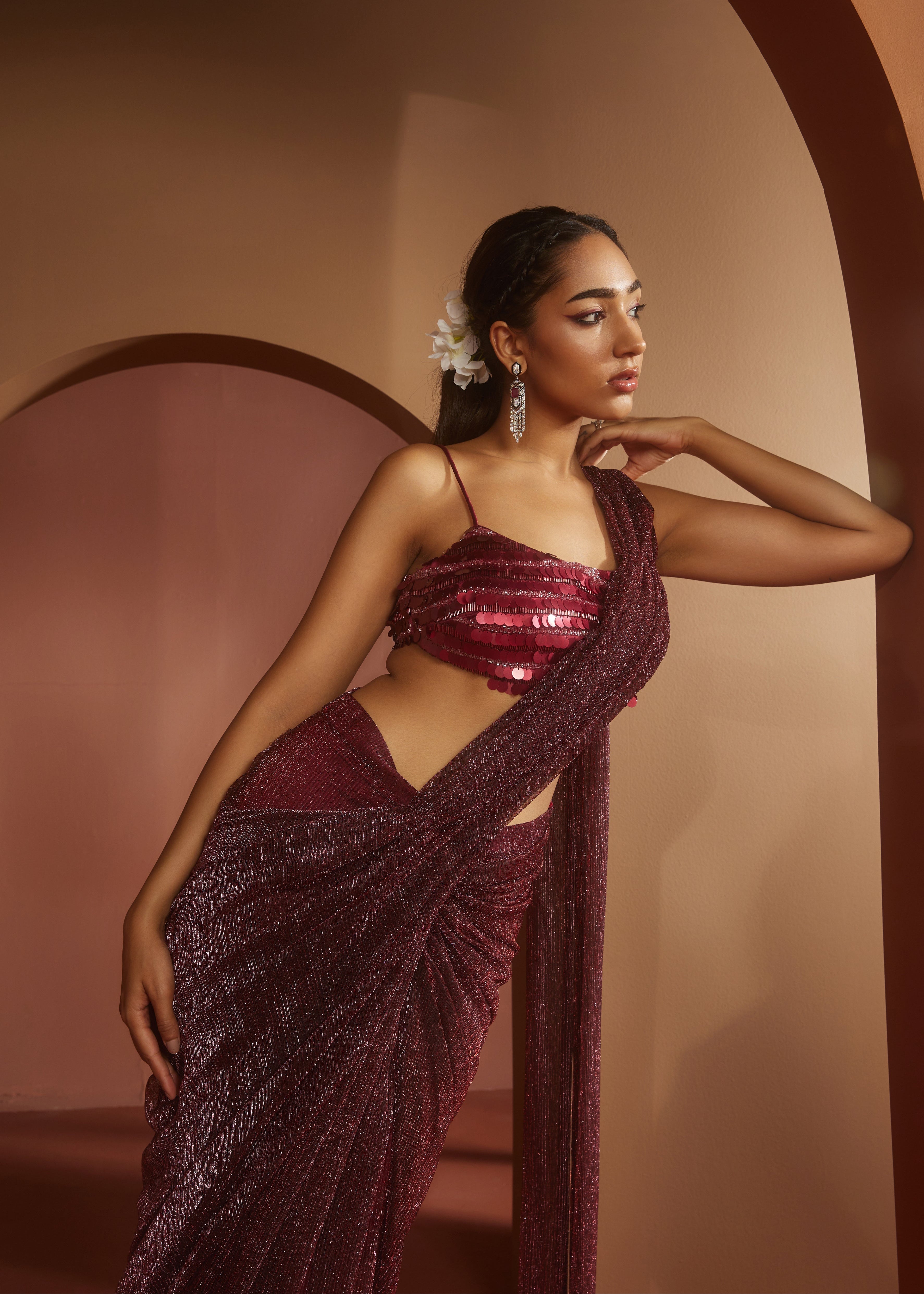 Chic woman in a Humaida Maroon Shimmer Pre-Draped Saree Set, exuding vibrant elegance