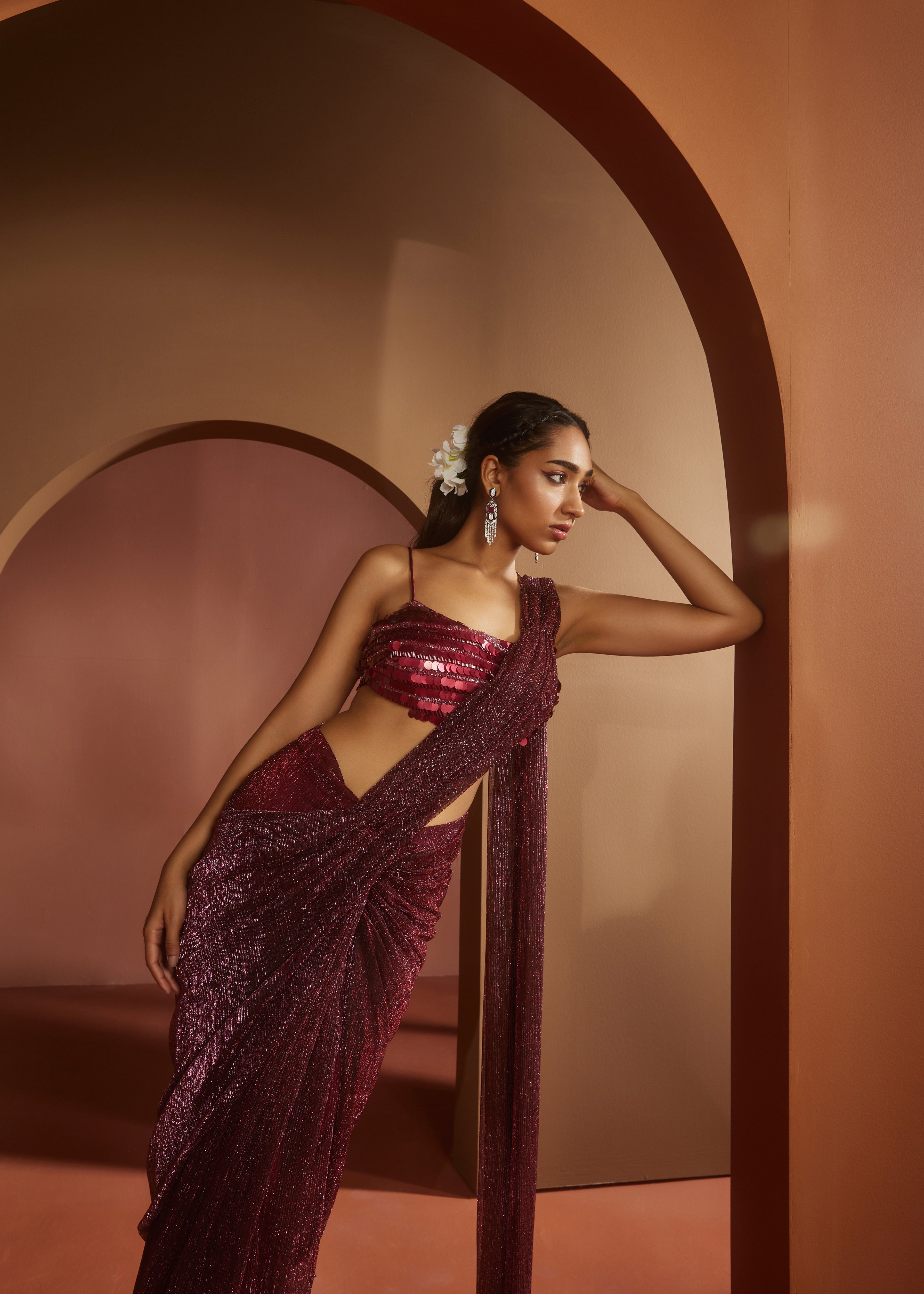 Chic woman in a Humaida Maroon Shimmer Pre-Draped Saree Set, exuding vibrant elegance